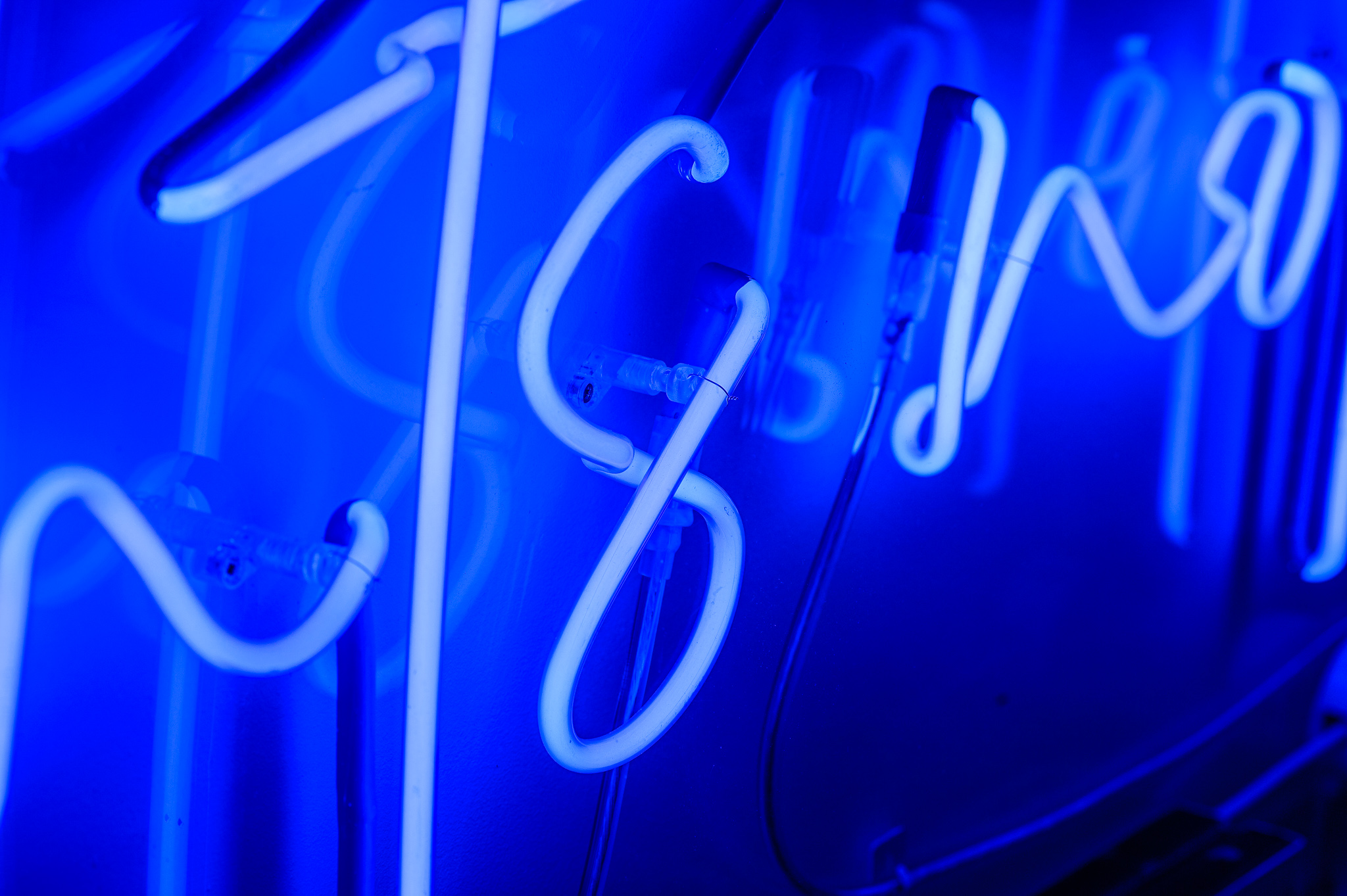 A close up of the blue marine neon lights in a stylised handwritten font